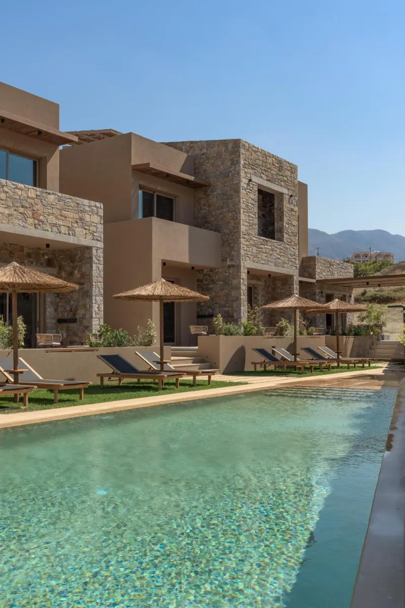 Villas overlooking pool with mountain backdrop