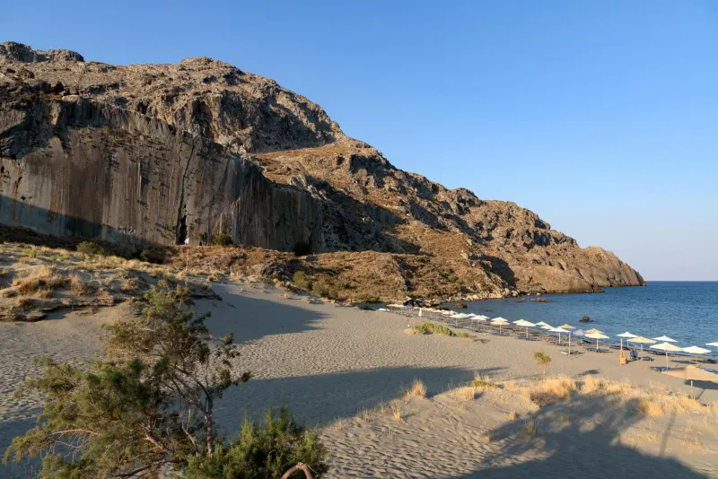 Sandy beach beneath rocky cliffs