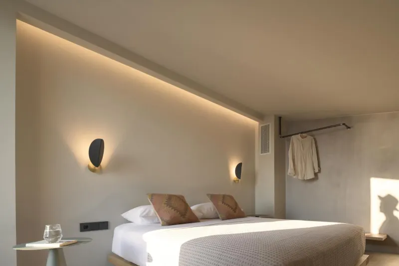 Bed with ambient lighting and wall sconces