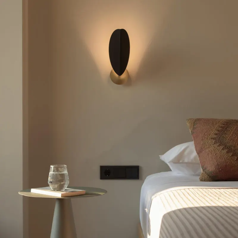 Bedside table with warm wall sconce