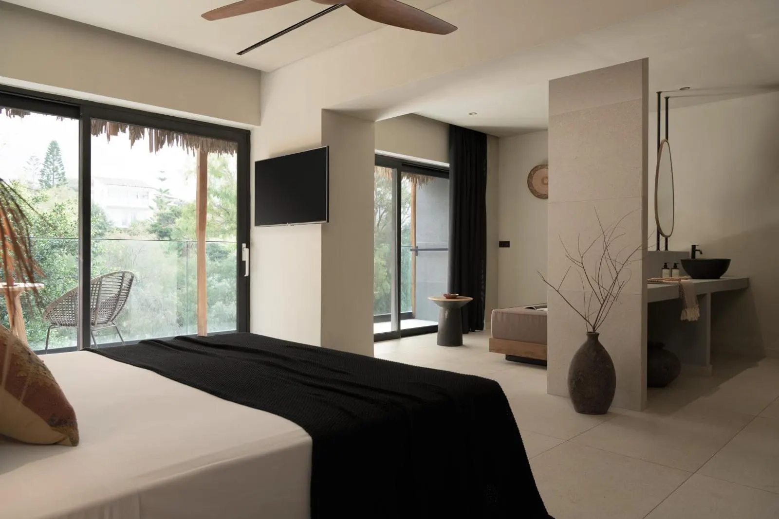 Bedroom with balcony and open bathroom area