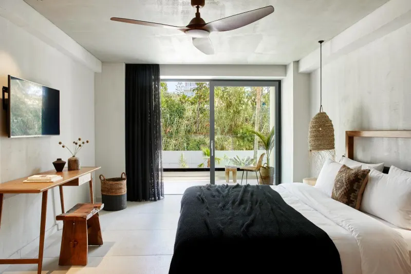 Bedroom with large window overlooking greenery