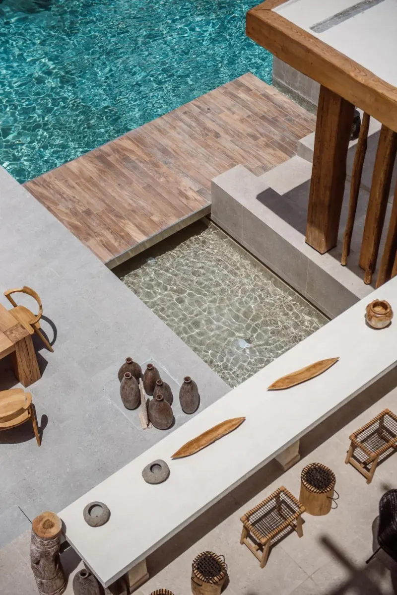 Overhead view of pool deck and wooden furniture
