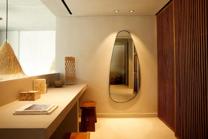Entryway with oval mirror and wood slat wall