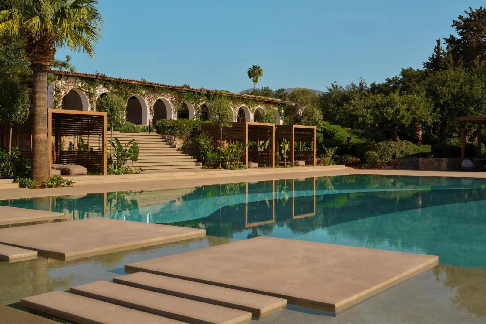 Poolside with arched colonnade and palm trees