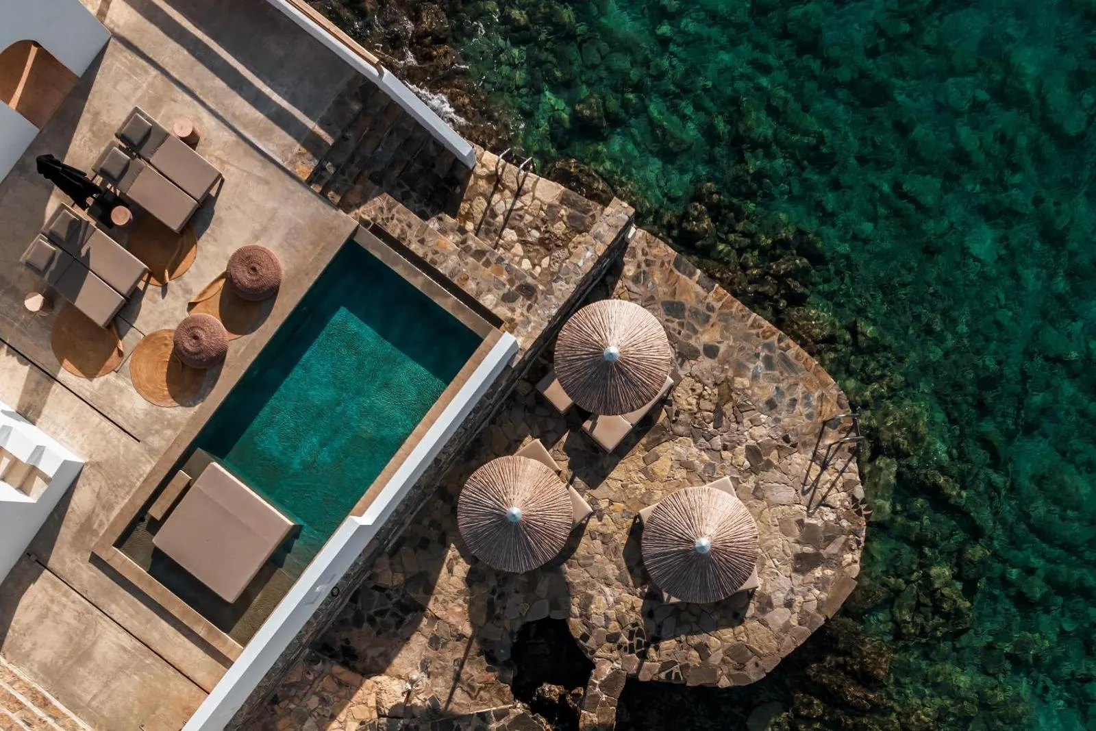 Aerial view of rooftop pool overlooking sea