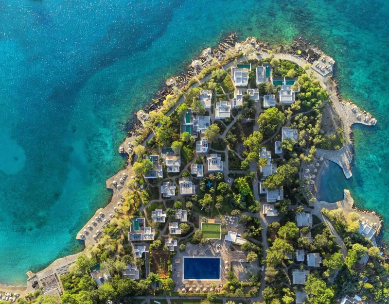 Aerial view of resort peninsula with pools and greenery