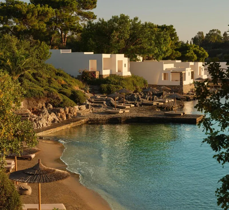 Coastal villas overlooking calm bay at sunset