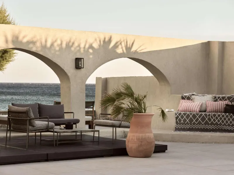 Terrace seating with sea view through arches