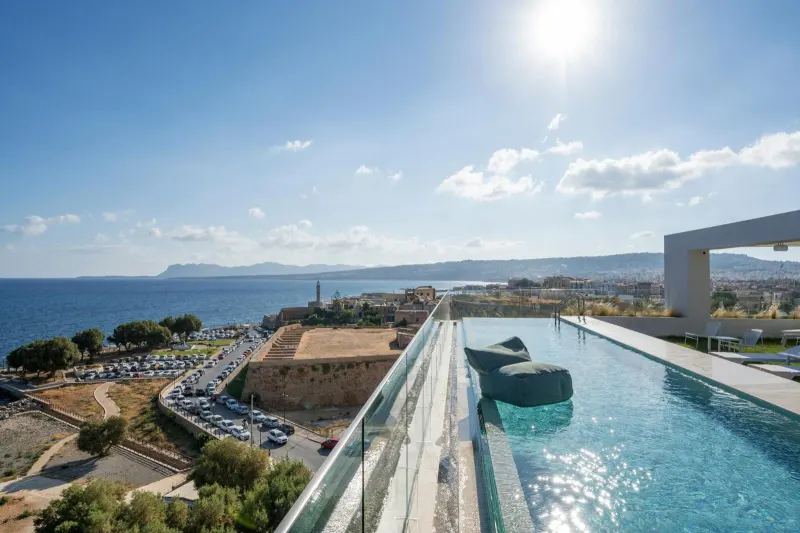 Sunny rooftop pool overlooking sea and old town