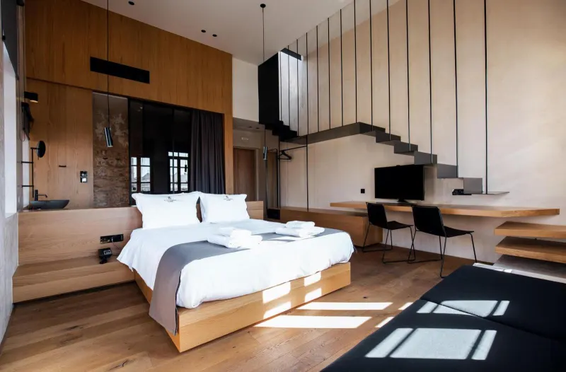 Loft bedroom with staircase and wooden furnishings