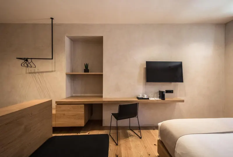 Bedroom corner with wall-mounted TV and desk