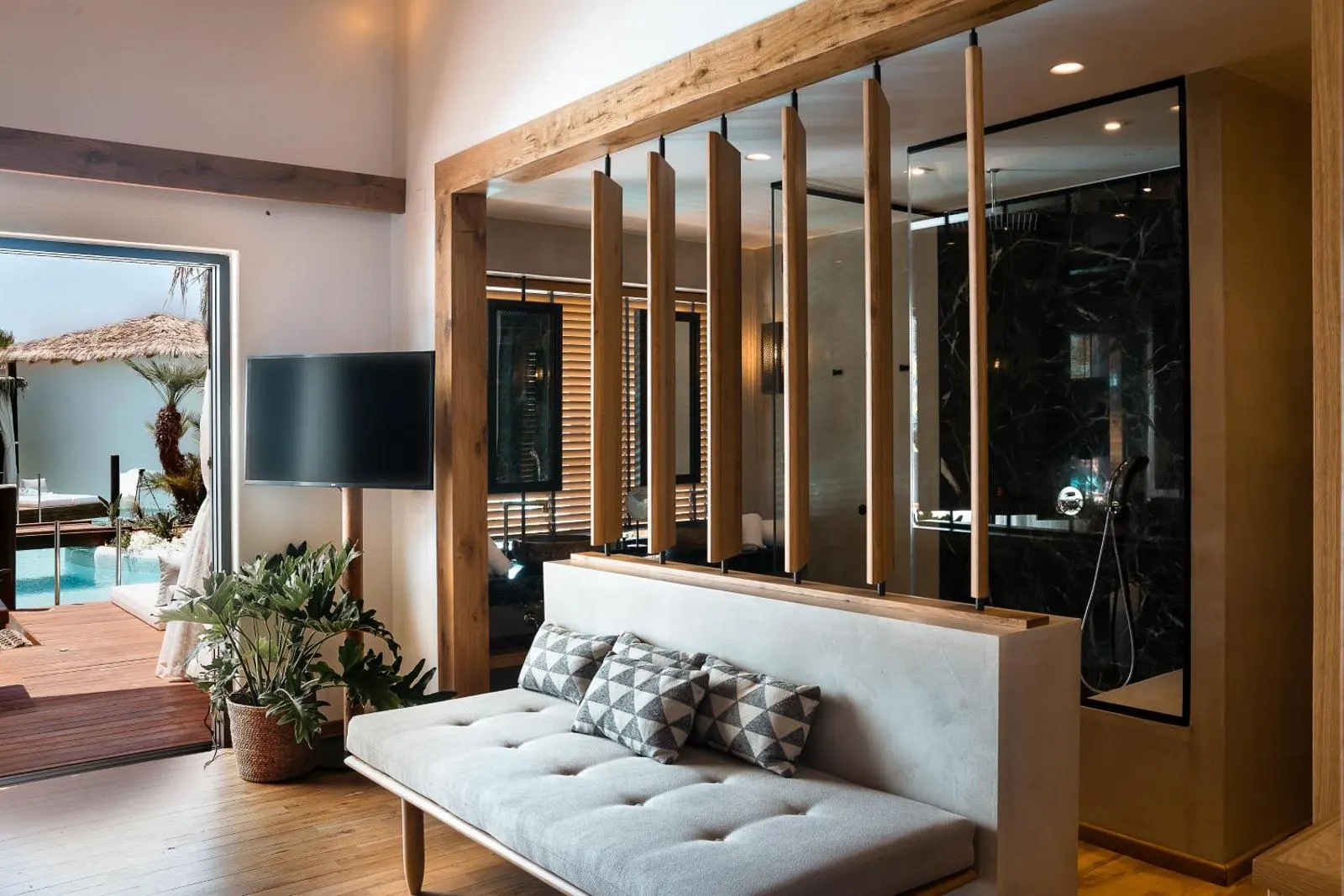 Modern living area with wooden slat divider and sofa