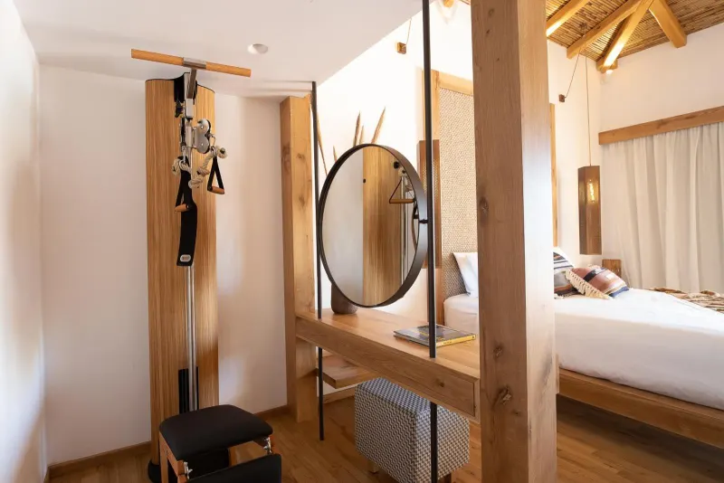 Bedroom nook with exercise equipment and round mirror