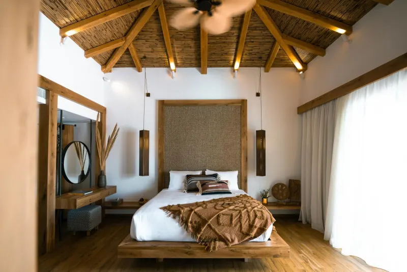 Bedroom with woven headboard and thatched ceiling
