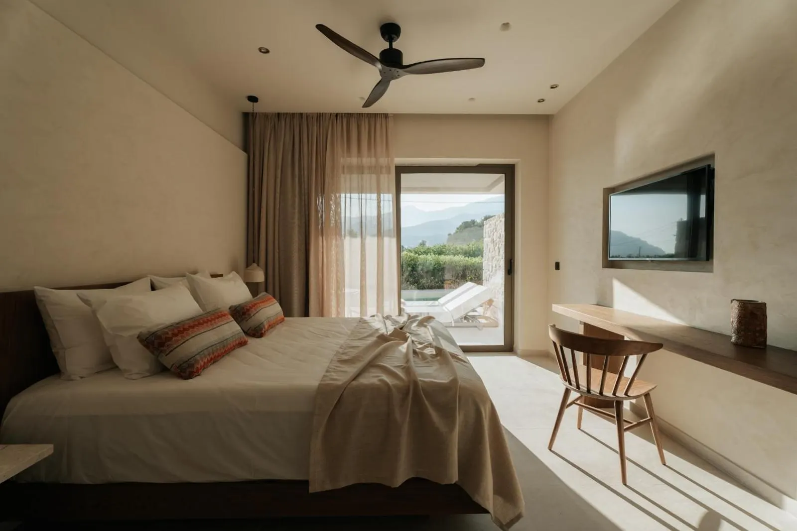Bedroom with terrace doors open to mountain view