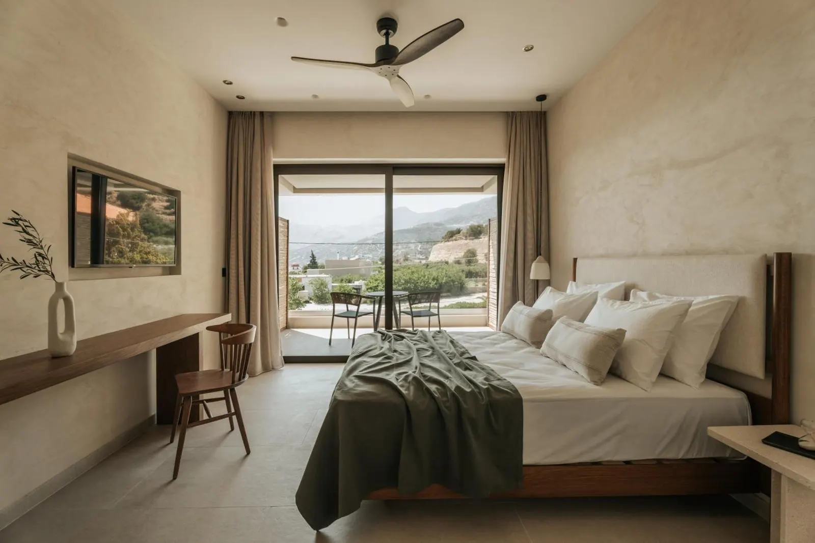 Bedroom with bed facing balcony and sea view