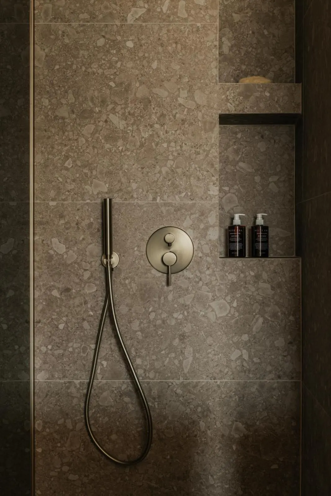Modern shower with stone tile and amenities