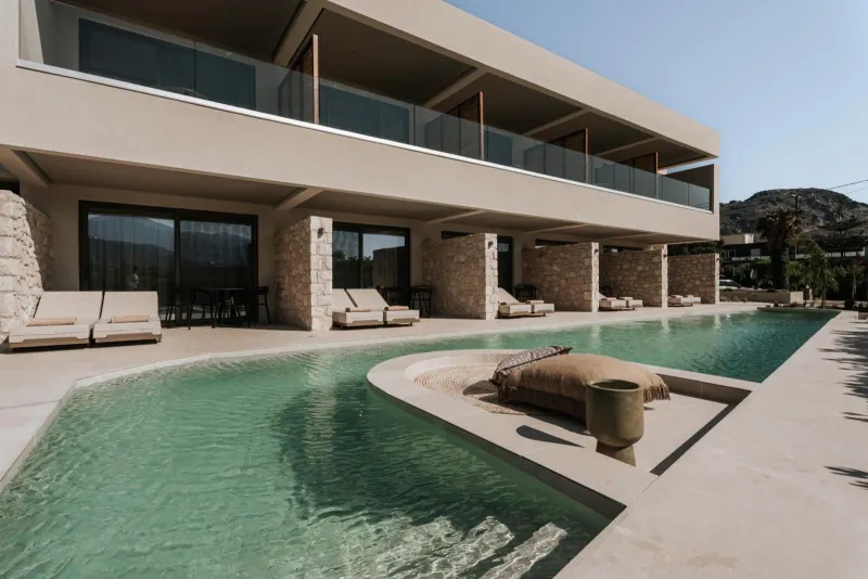 Villa exterior with pool and lounge chairs