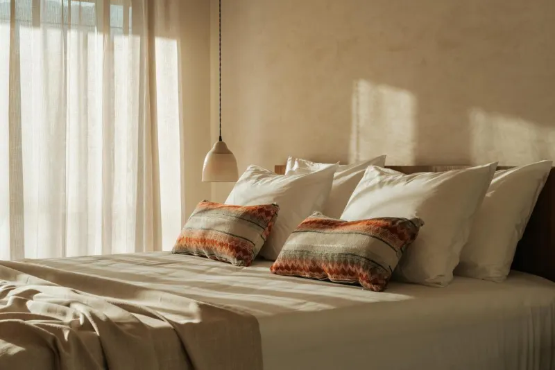 Close-up of bed with patterned pillows