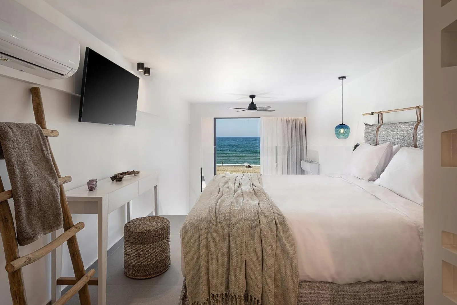 Bedroom with sea view through glass doors