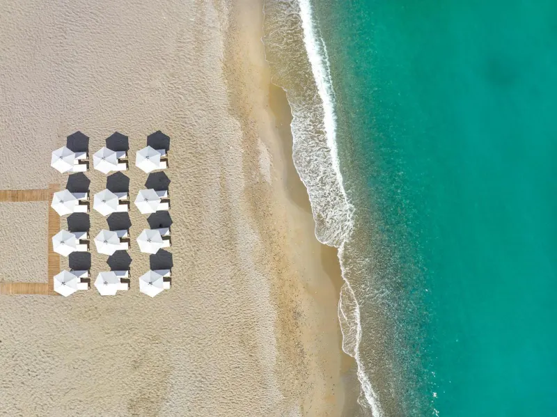 Aerial view of beach umbrellas and turquoise sea