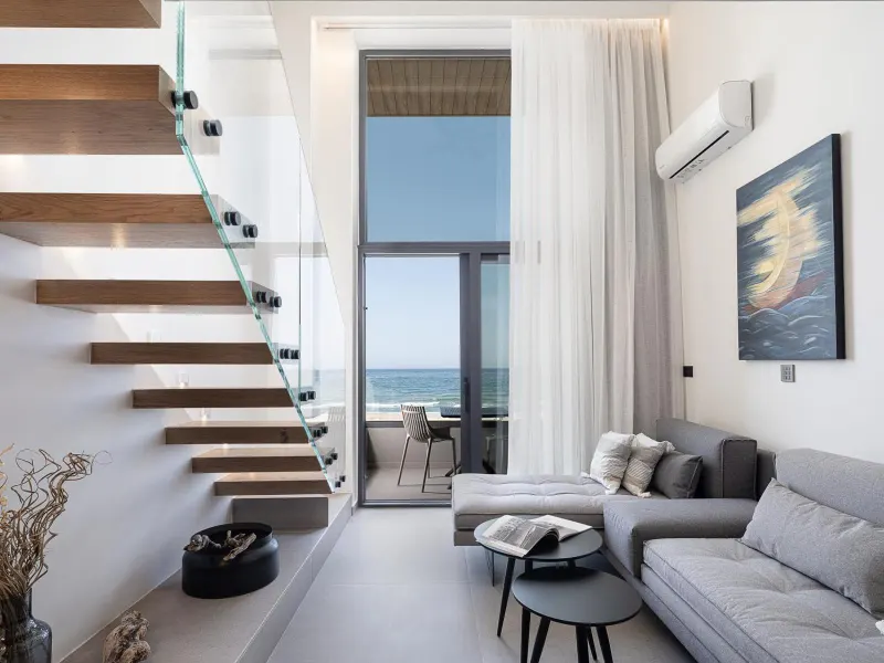 Living room with staircase and sea view balcony