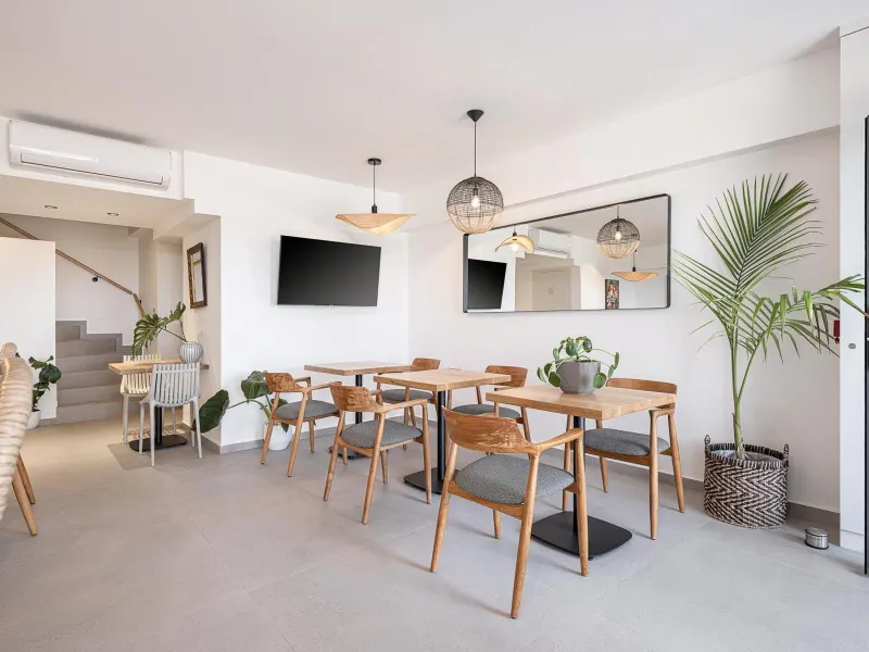 Dining area with wooden table and plants
