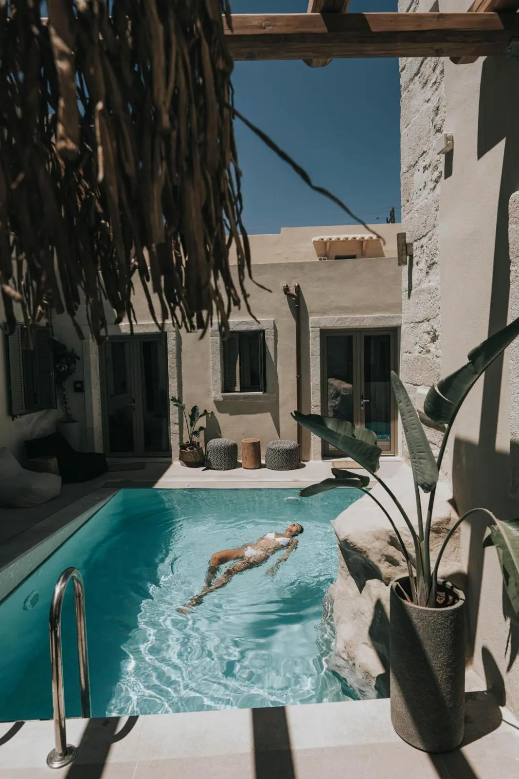 Courtyard pool with pergola and stone buildings