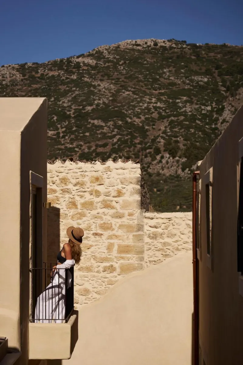 Woman on balcony with mountain backdrop