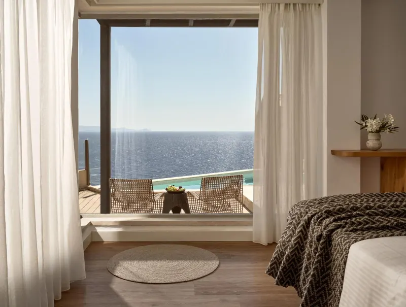 Bedroom with balcony and ocean view