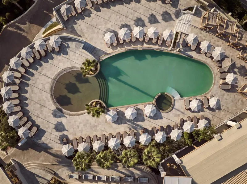 Aerial view of oval pool with umbrellas