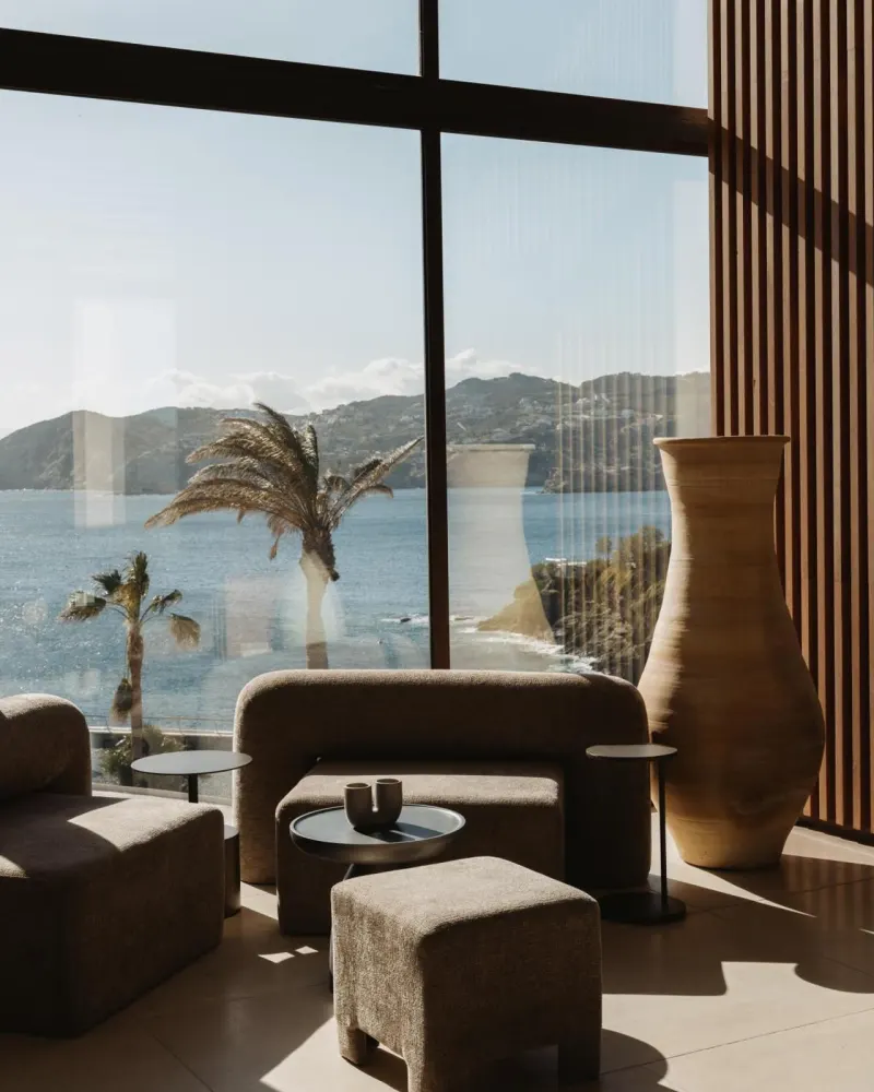 Lounge seating area with sea view through window