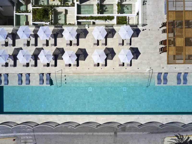 Aerial view of pool with umbrellas and sunbeds
