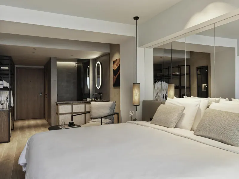 Modern bedroom with mirrored wall and dressing area