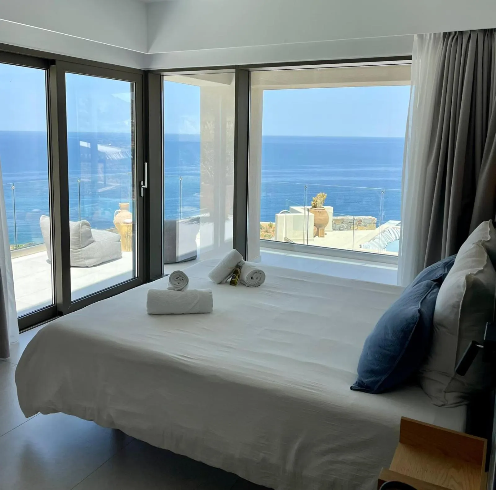 Bedroom with large windows overlooking the sea