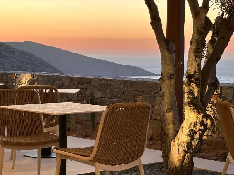 Outdoor dining tables with sunset sea view