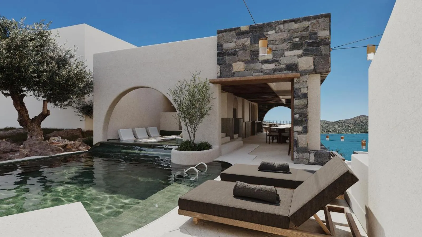 Pool terrace with loungers and sea view