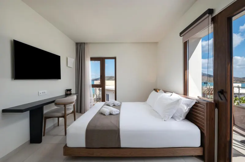 Bedroom with TV and balcony doors