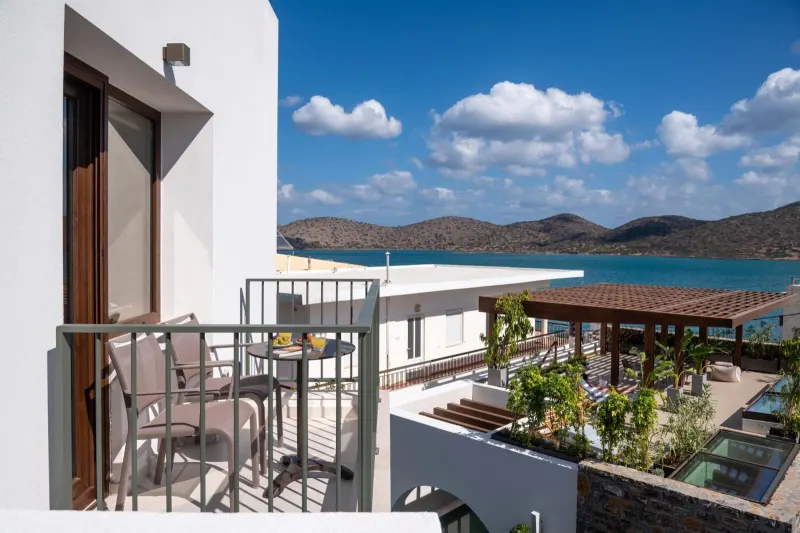 Balcony seating overlooking sea and pool