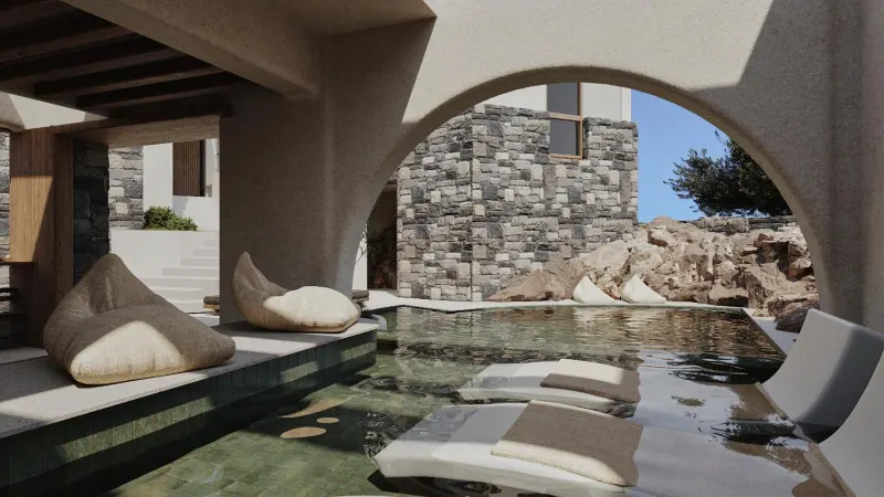 Stone archway pool with cushioned loungers