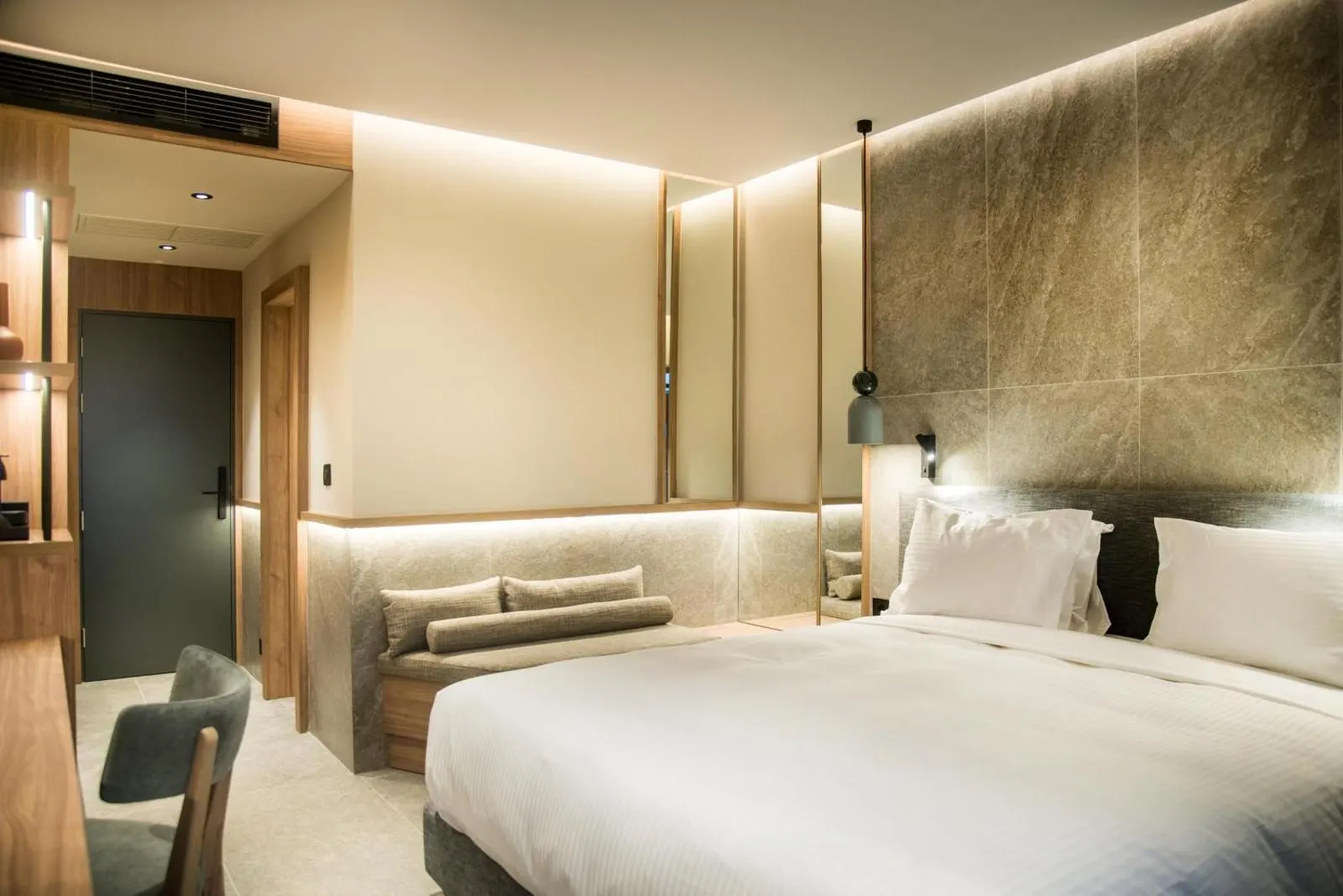 Modern hotel bedroom with warm lighting