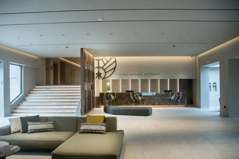 Elegant hotel lobby with staircase and reception desk