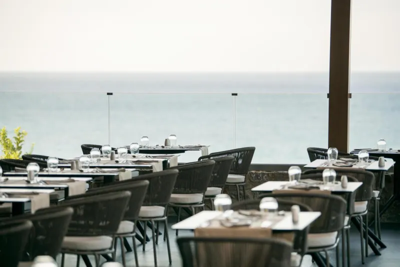 Outdoor dining tables overlooking the sea