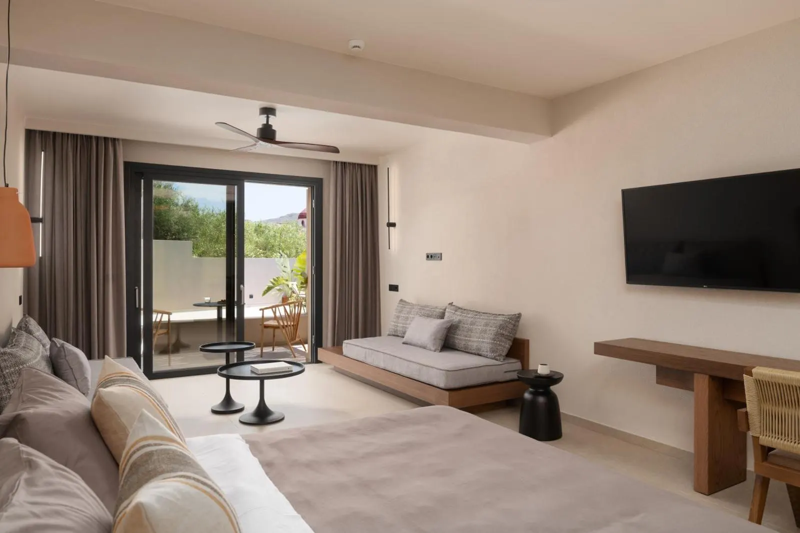 Bedroom with sofa, TV, and terrace access