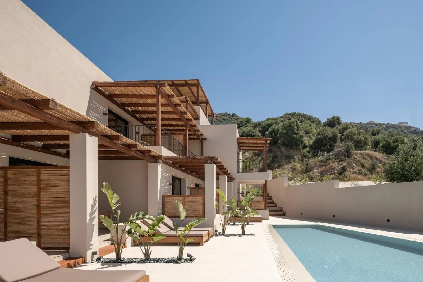 Exterior view of villas with pool and pergolas