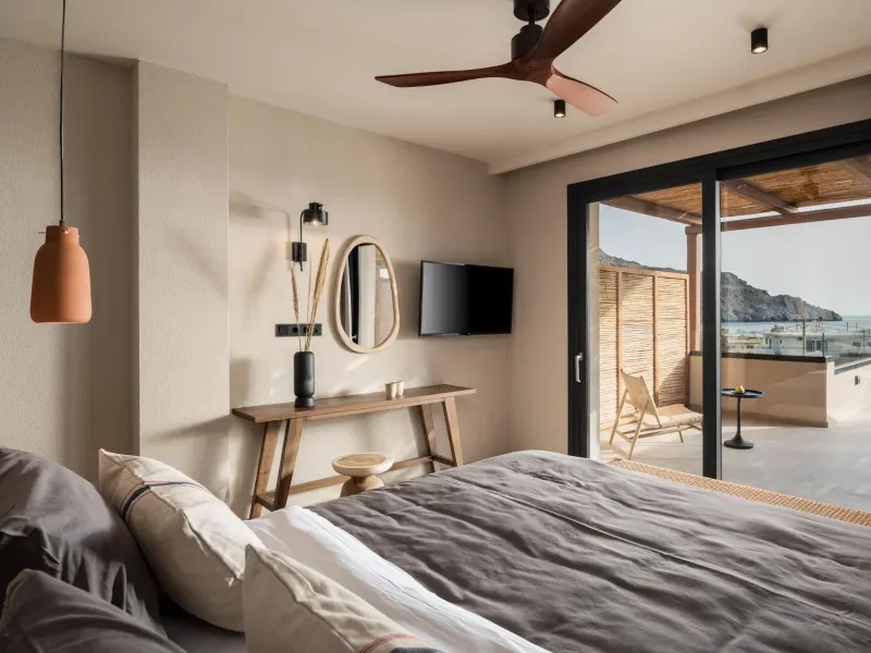 Bedroom with sea view balcony and ceiling fan