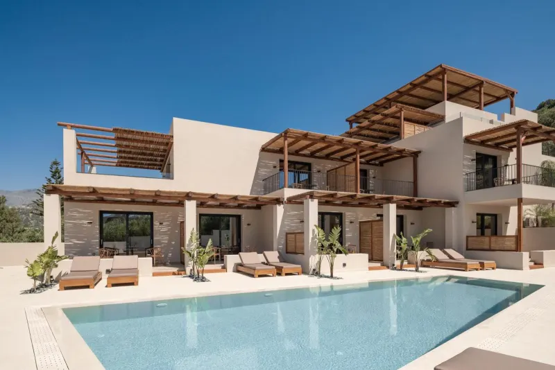 Villa exterior with pool and wooden pergolas