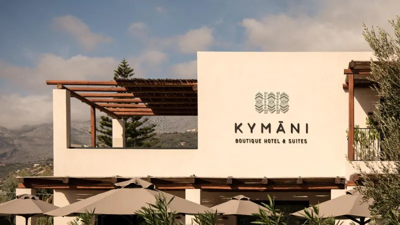 Hotel entrance sign with mountain backdrop