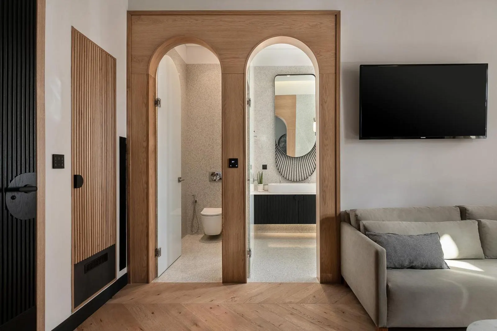Hallway with arched doorways leading to bathroom